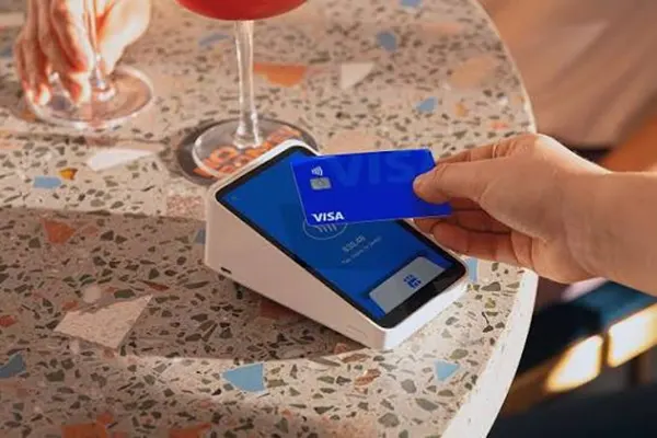  Image of tapping a credit card on a credit card terminal.
